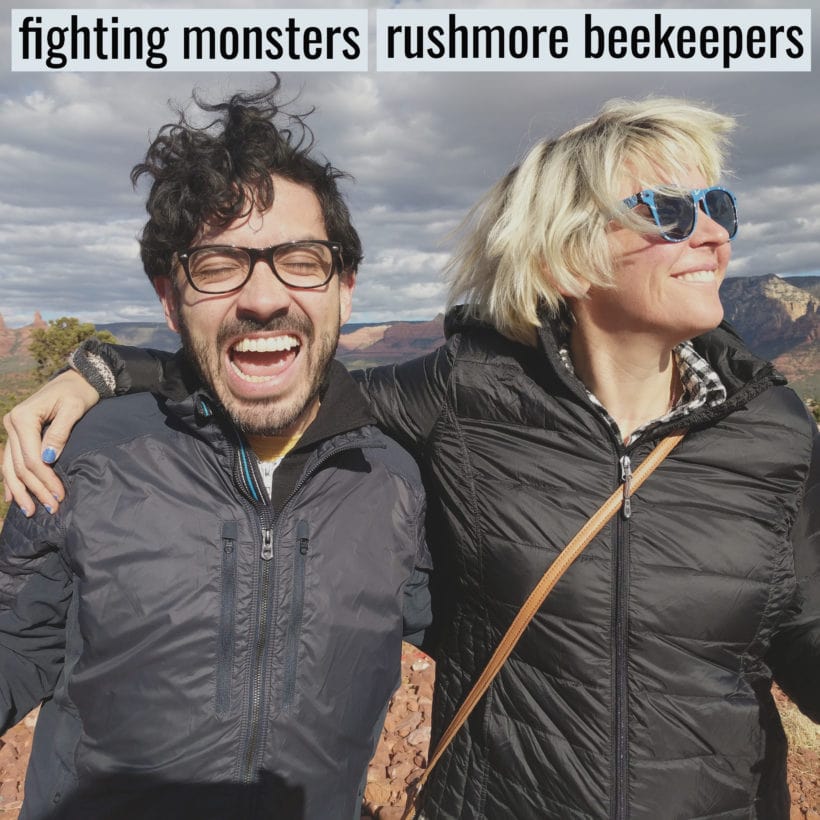 Amanda and Zach stand among mountains in the desert